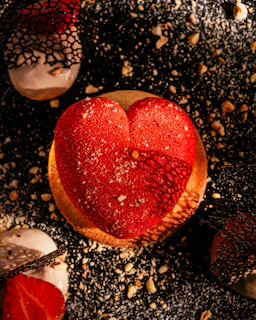 A tempting shamrock-shaped dessert, dusted with powdered sugar and drizzled with chocolate.