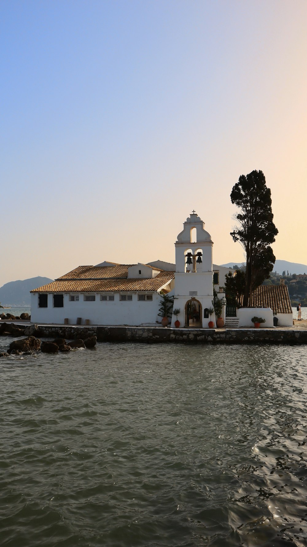 a white building sitting on top of a body of water