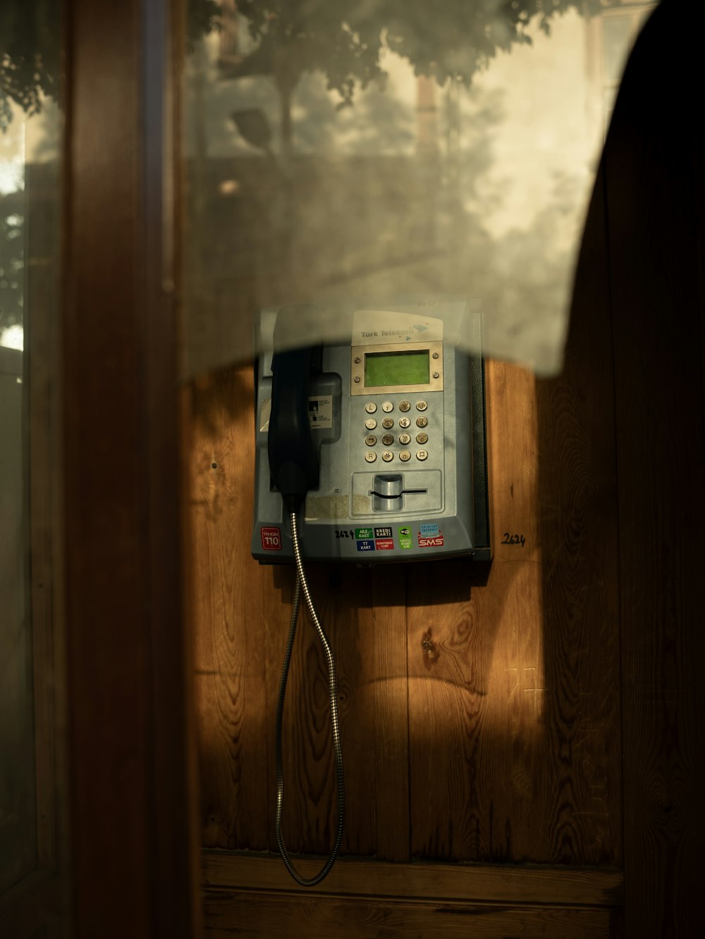 an old style phone on a wooden wall
