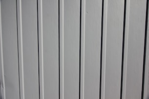 a close up of the side of a white fence