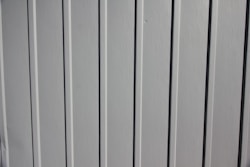 a close up of the side of a white fence