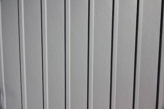 A close-up photo of smooth white drywall panels freshly installed in a modern living room.