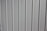 A close-up view of a vertical panel construction with subtle grooves and an off-white or light gray color.