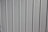 A close-up view of a vertical panel construction with subtle grooves and an off-white or light gray color.