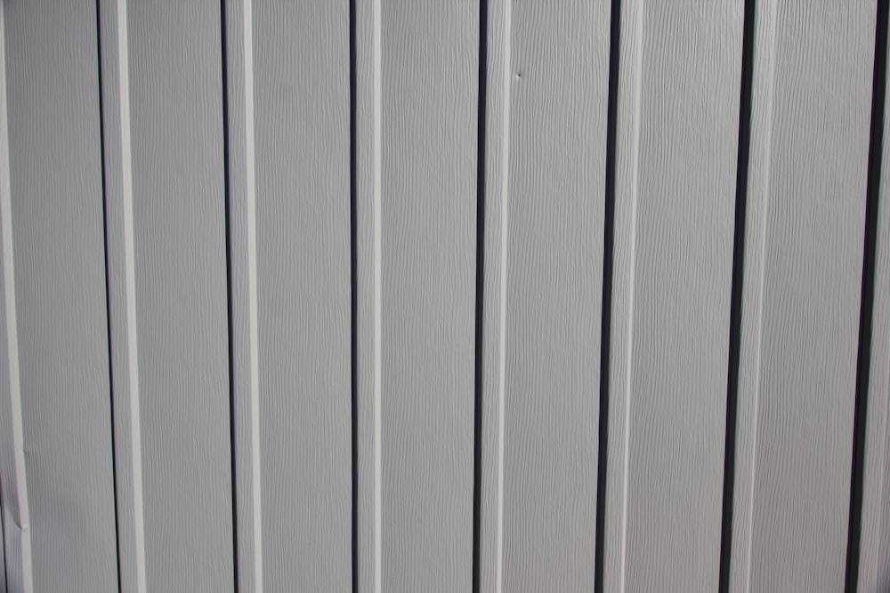 a close up of the side of a white fence