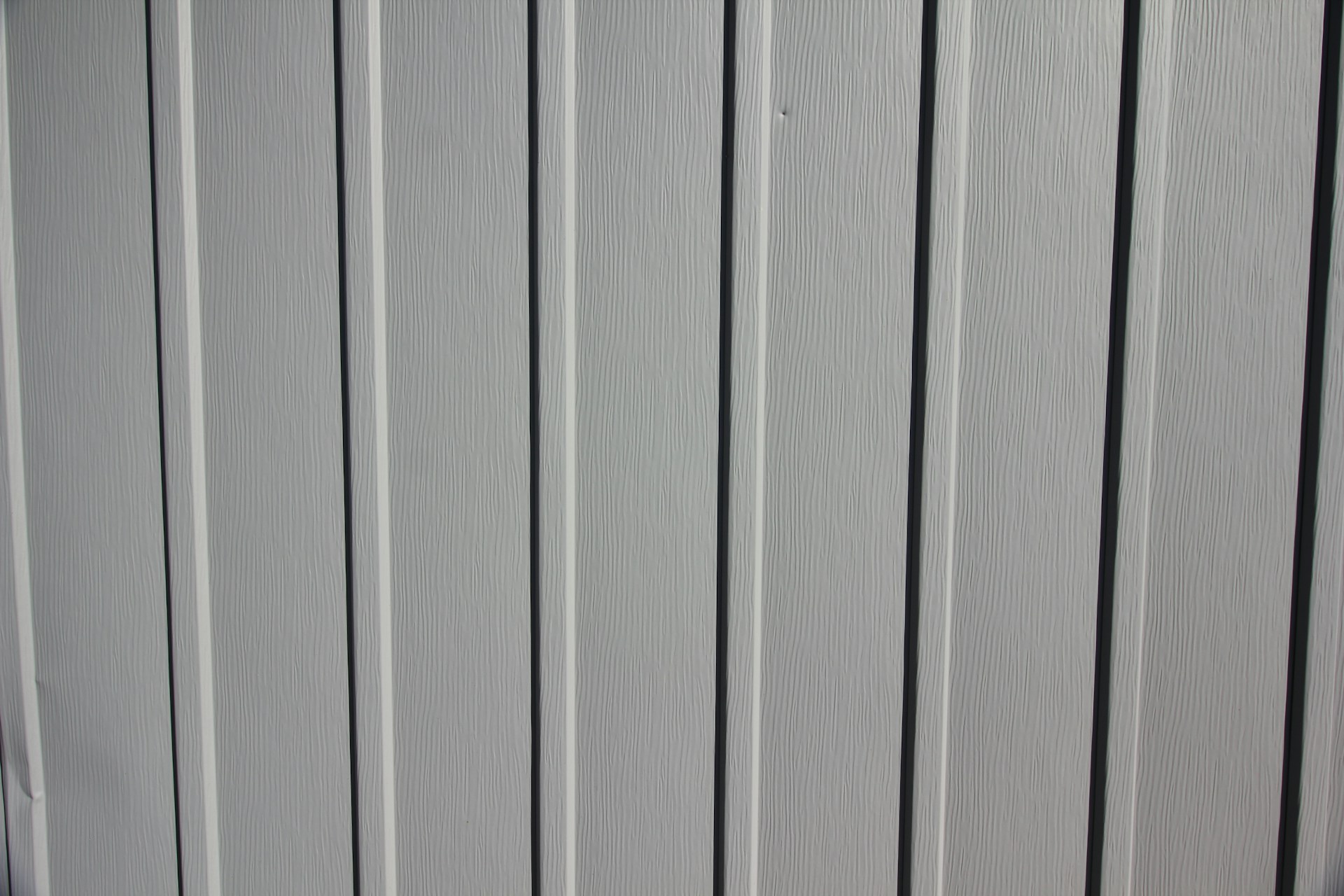 a close up of the side of a white fence
