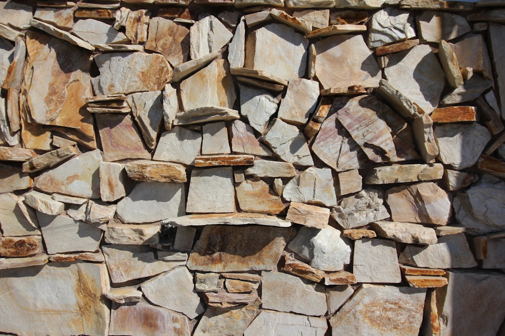 a stone wall made of rocks with a hole in the middle