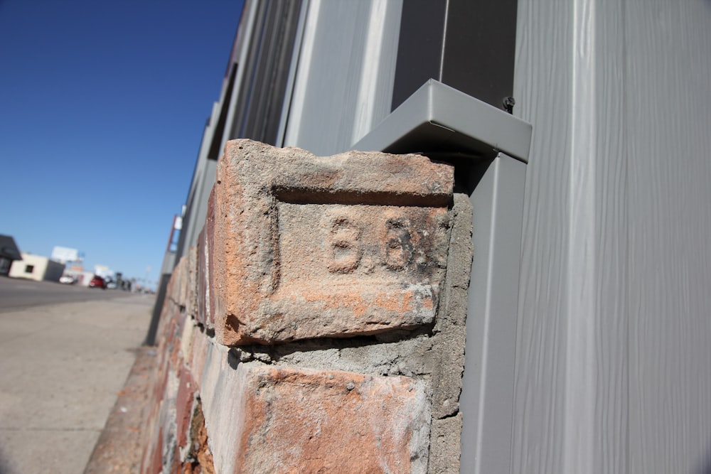 a close up of a brick on the side of a building