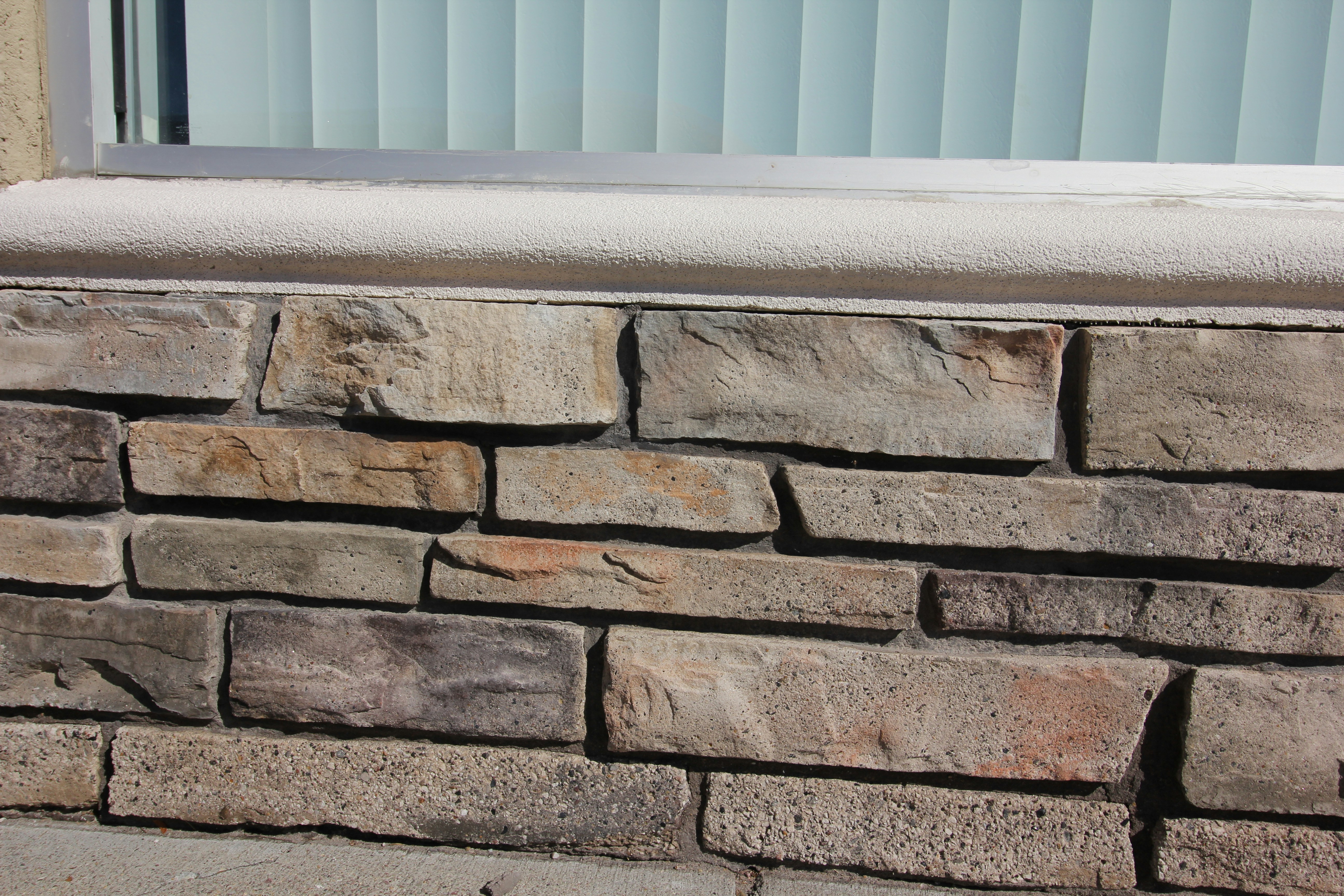 a close up of a brick wall with a window