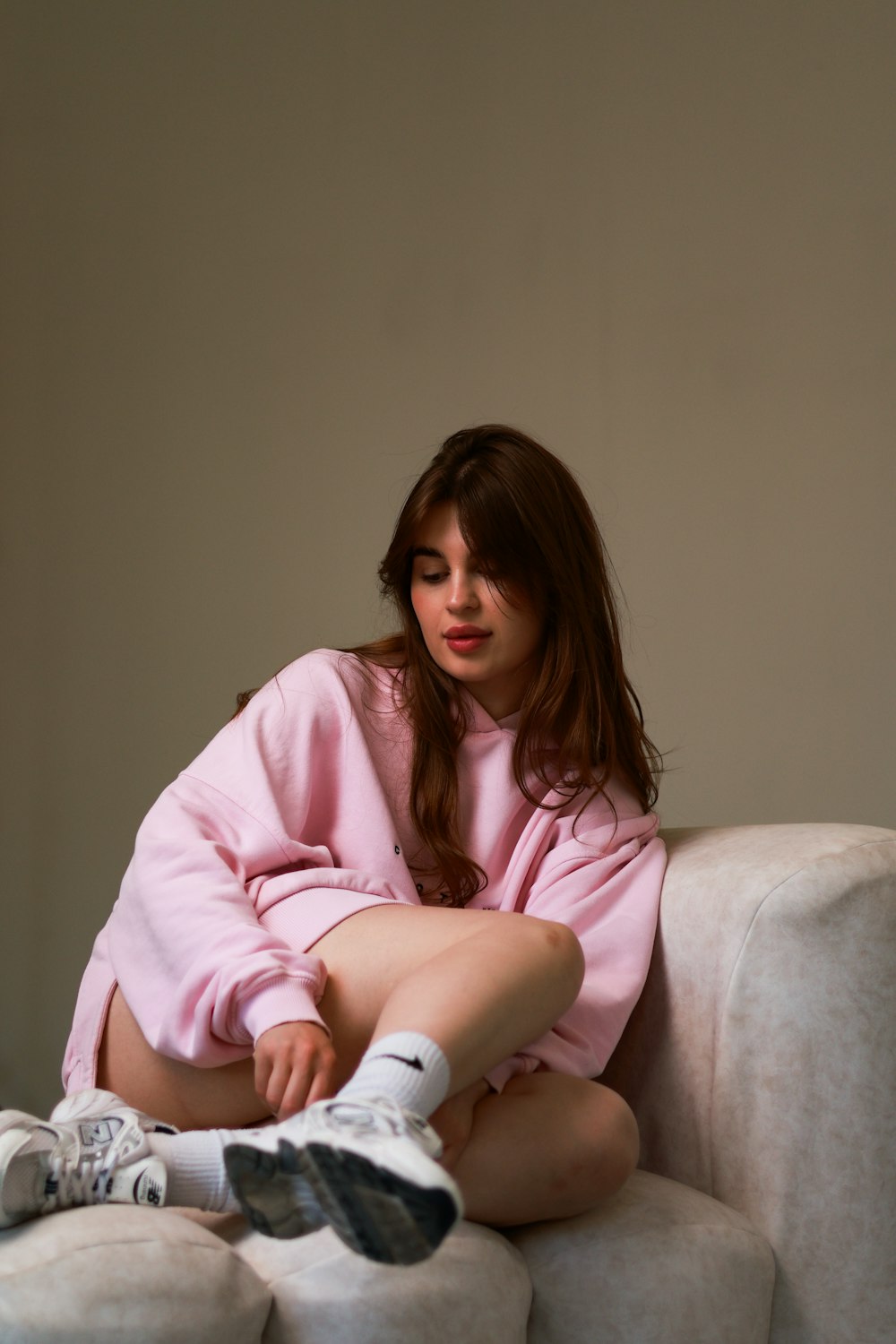 a woman sitting on top of a white couch