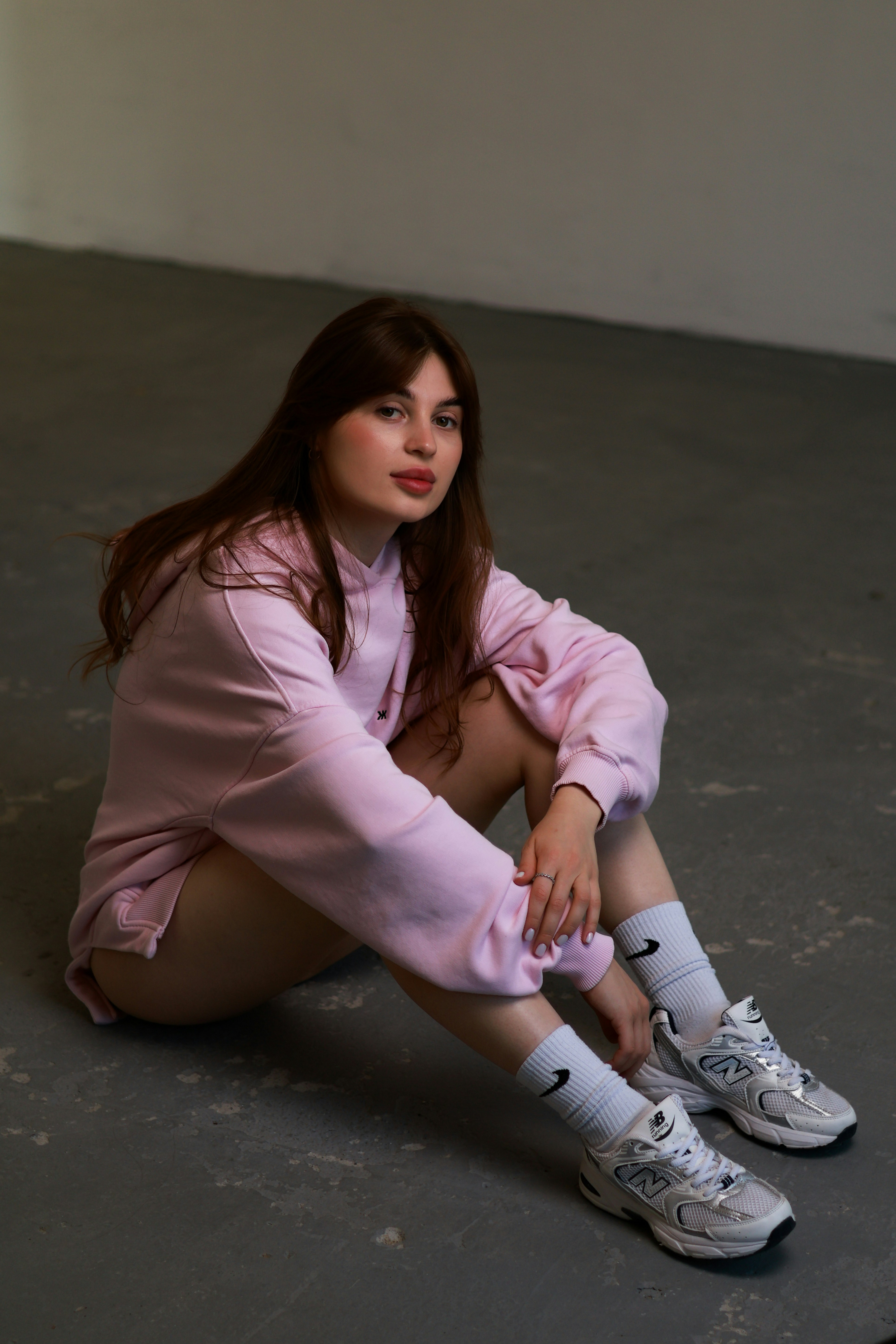 a woman sitting on the ground with her legs crossed