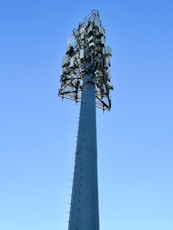 a very tall tower with a bunch of cell phones on top of it