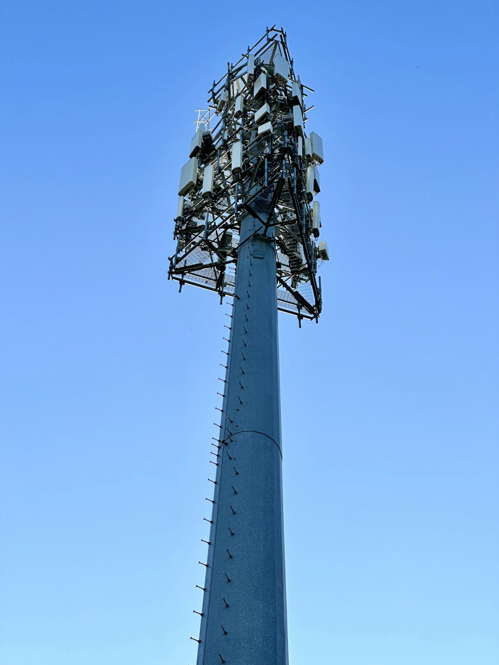 a very tall tower with a bunch of cell phones on top of it