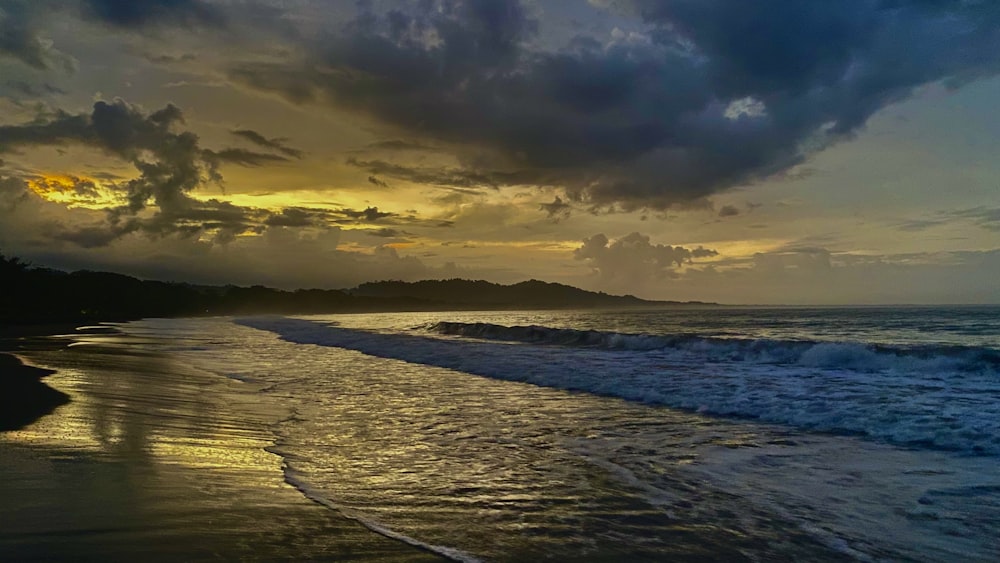 a beach with waves coming in to shore