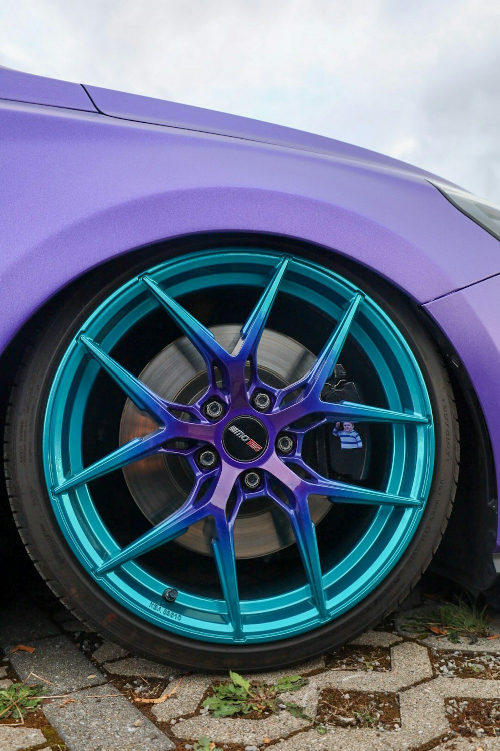 a close up of a purple and blue car tire