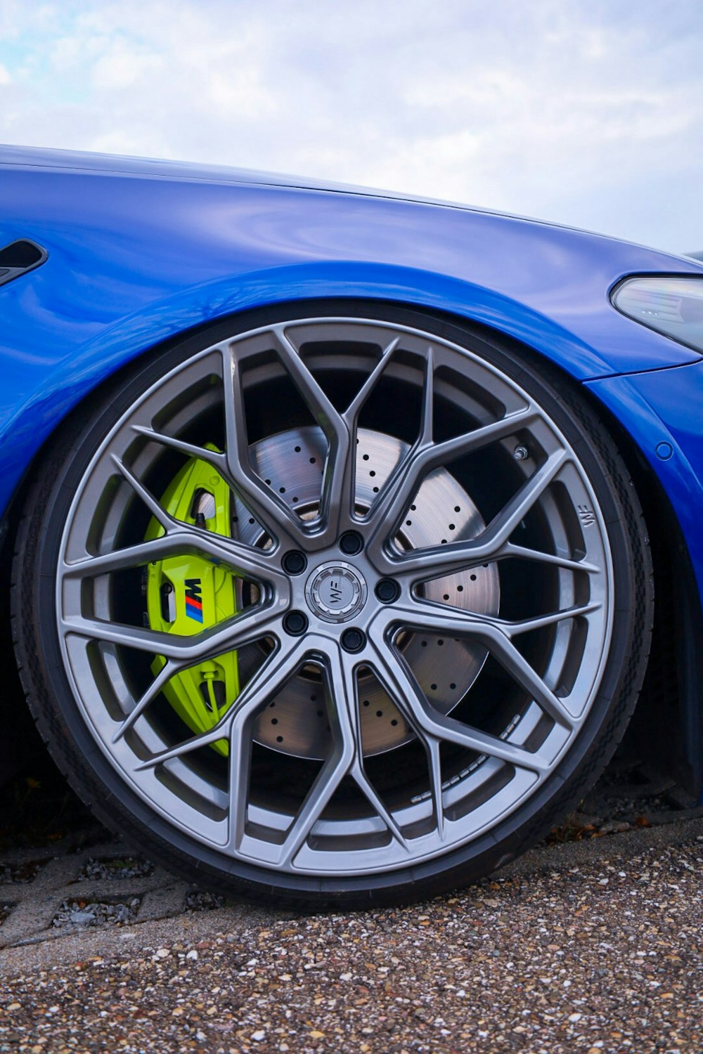 a close up of a blue sports car tire