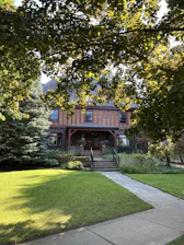 Front porch of a charming bungalow surrounded by lush greenery in East Atlanta