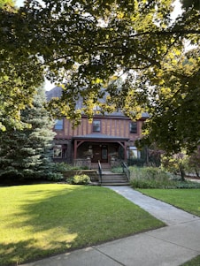 A welcoming front porch of a charming New Jersey home surrounded by lush greenery.