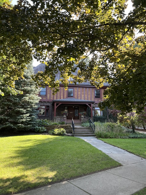 Charming exterior of a classic house in The Woodlands surrounded by lush greenery