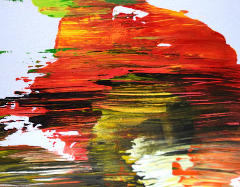 Close-up photo of vibrant paint splatters on a canvas, highlighting dynamic color contrasts.