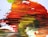A close-up of a vibrant painting in progress, highlighting bold colors and dynamic brush strokes.