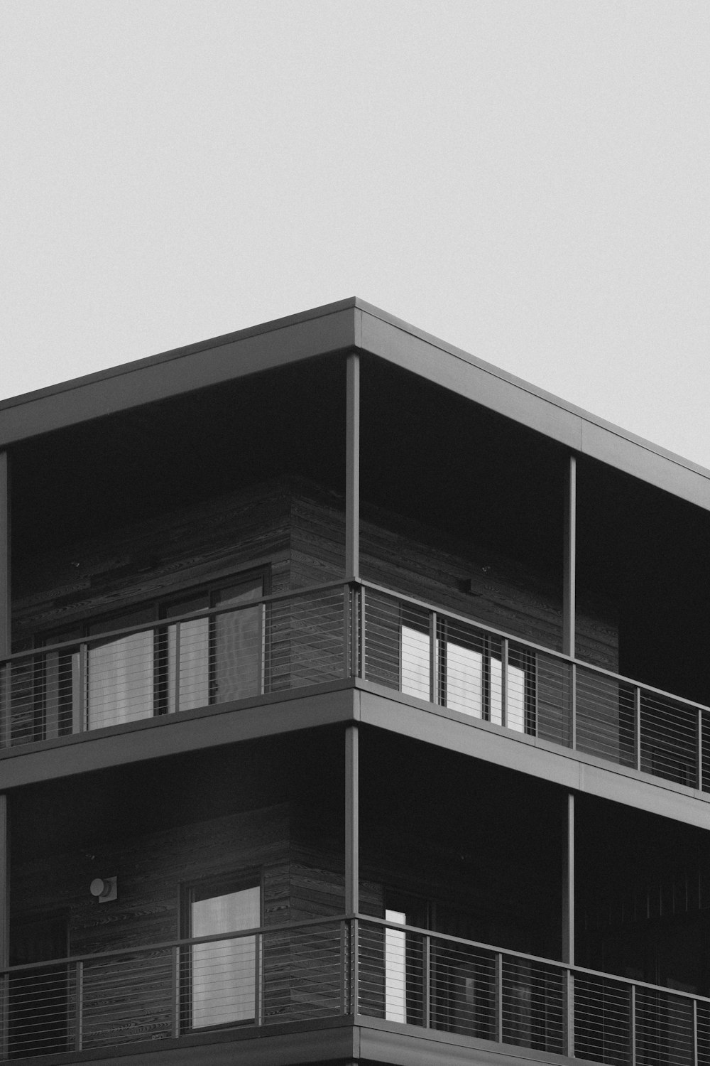 a black and white photo of a building with balconies