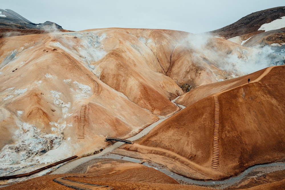 a view of a mountain with a train going through it