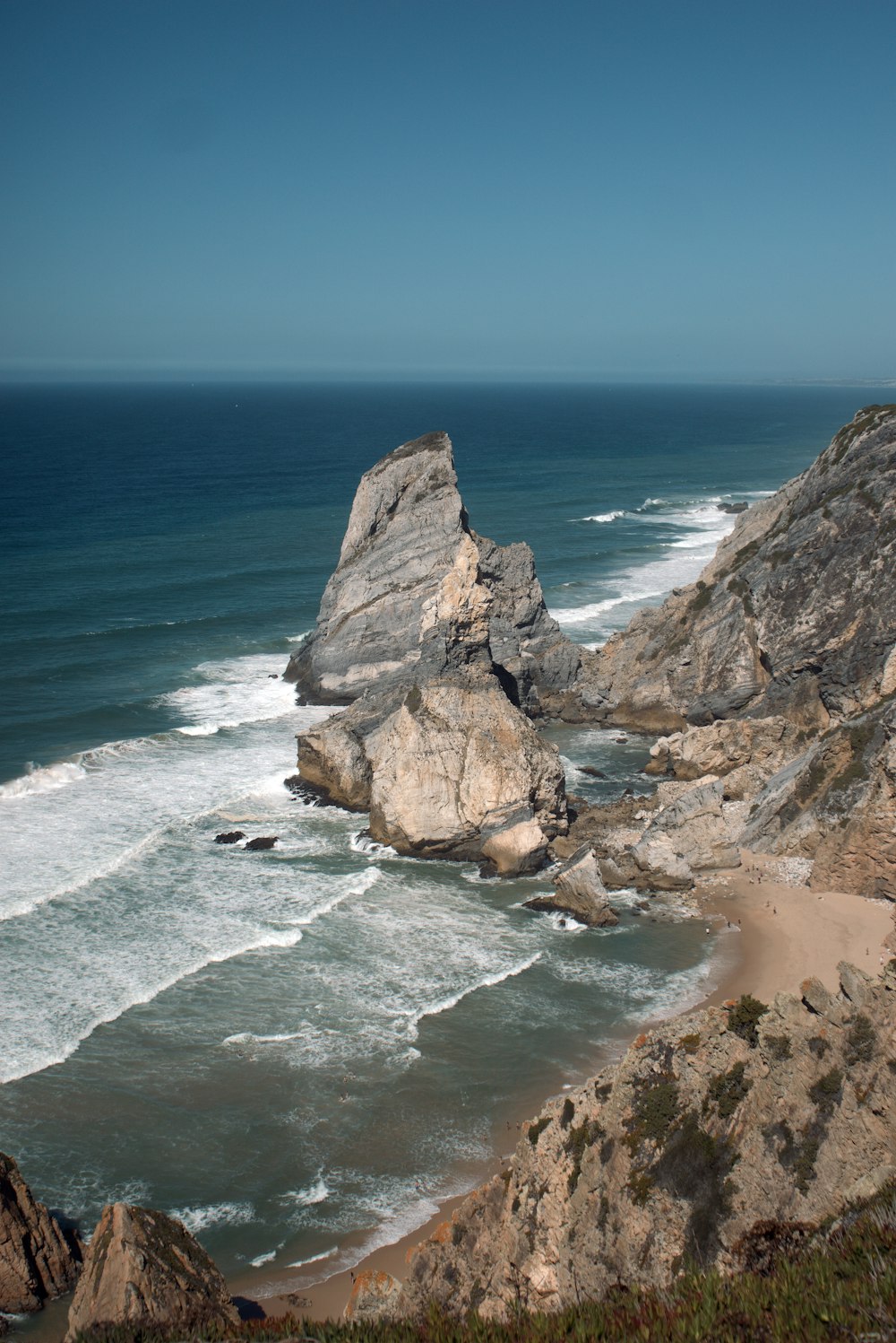 a view of the ocean from the top of a hill