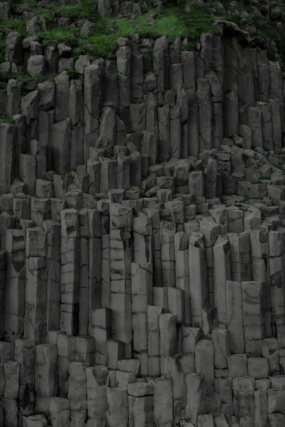 a black and white photo of a large rock formation