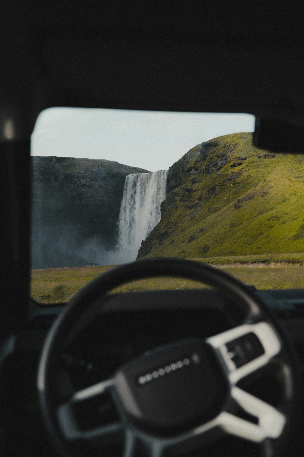 a view of a waterfall from inside a vehicle