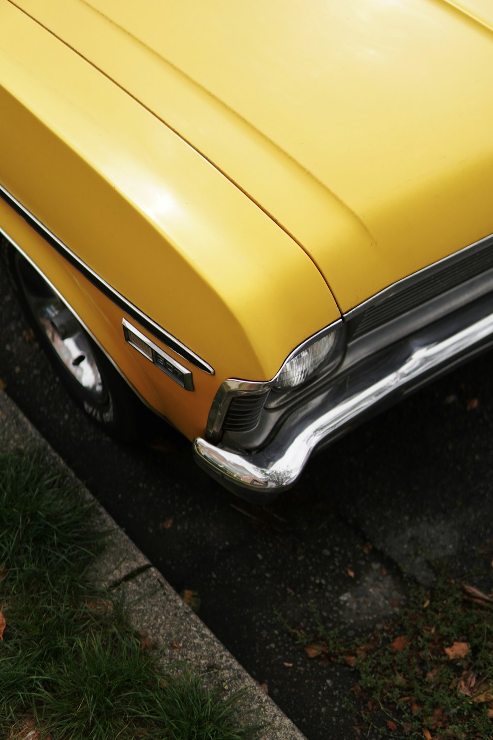 a yellow car parked on the side of the road