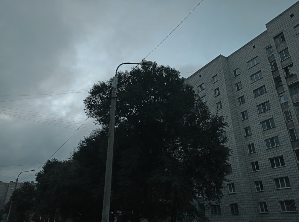 a street light sitting next to a tall building