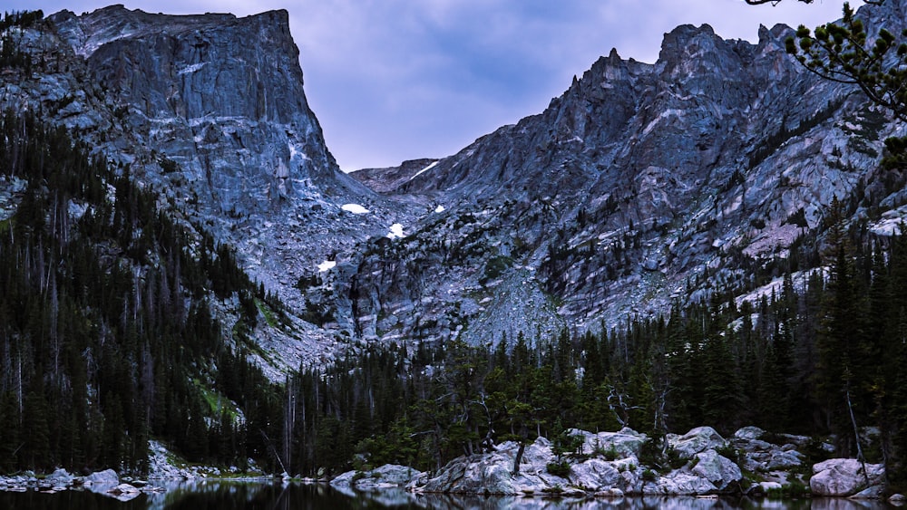 a mountain range with a lake in the foreground