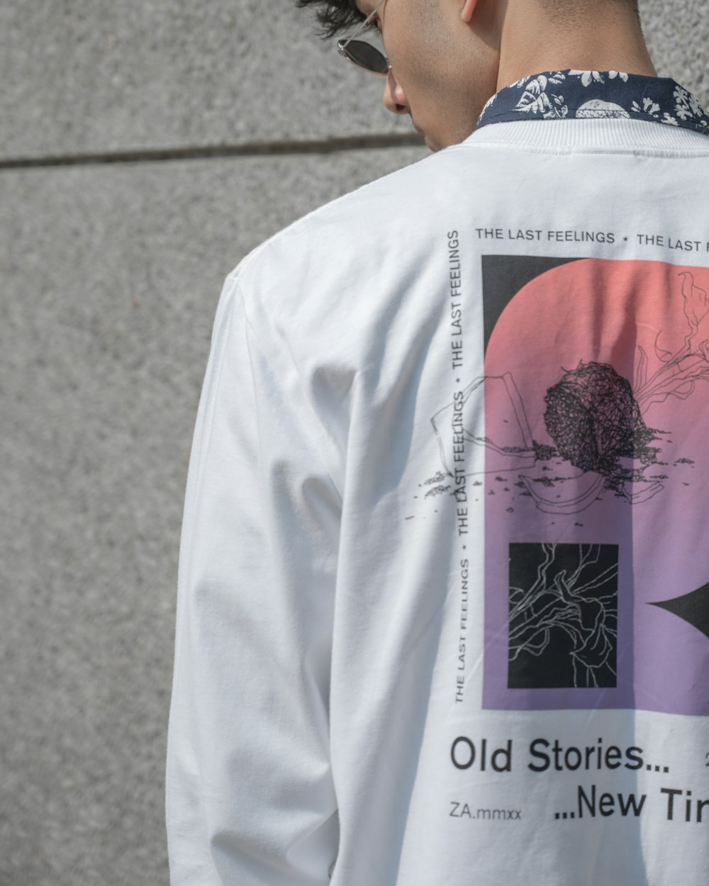 a man wearing a white shirt with a picture of a turtle on it