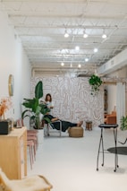 Interior designer reviewing plans inside a bright, stylish office space.