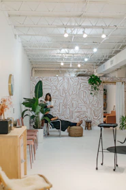 Therapist demonstrating a new technique with a client in a bright, welcoming space.