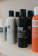 a white shelf topped with lots of different types of hair products