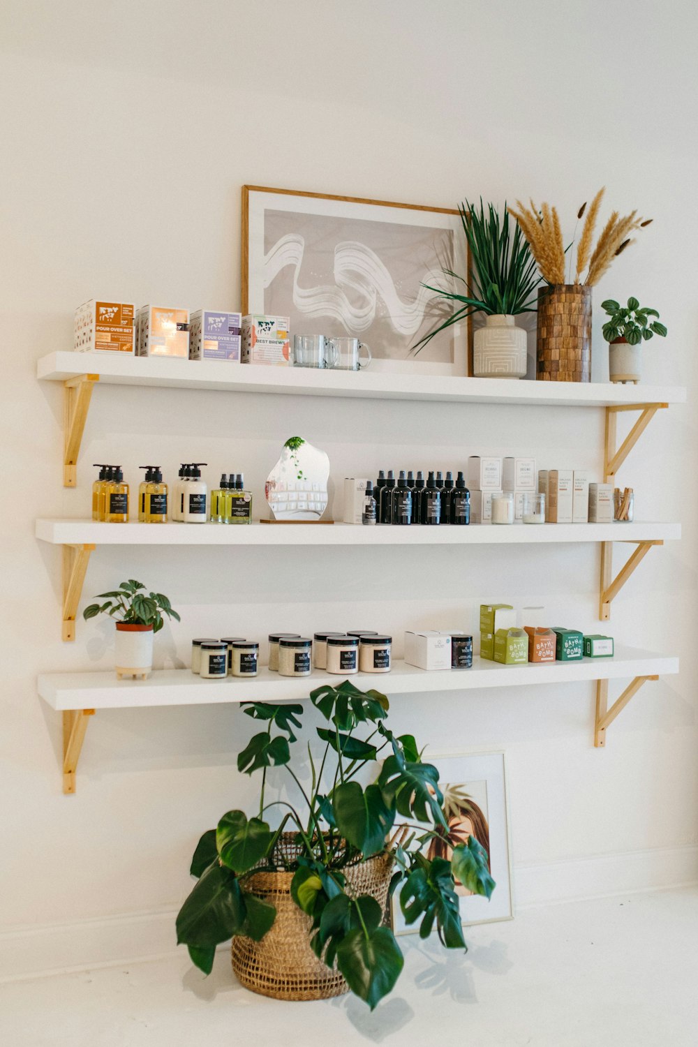 a shelf filled with lots of bottles and plants