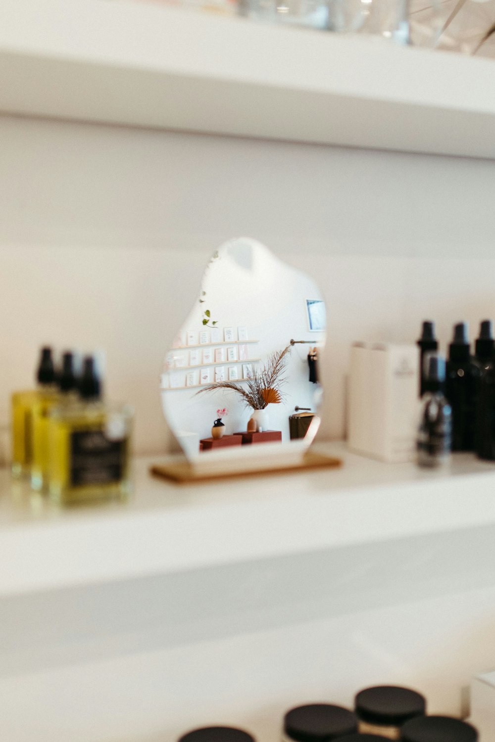 a mirror sitting on top of a white shelf