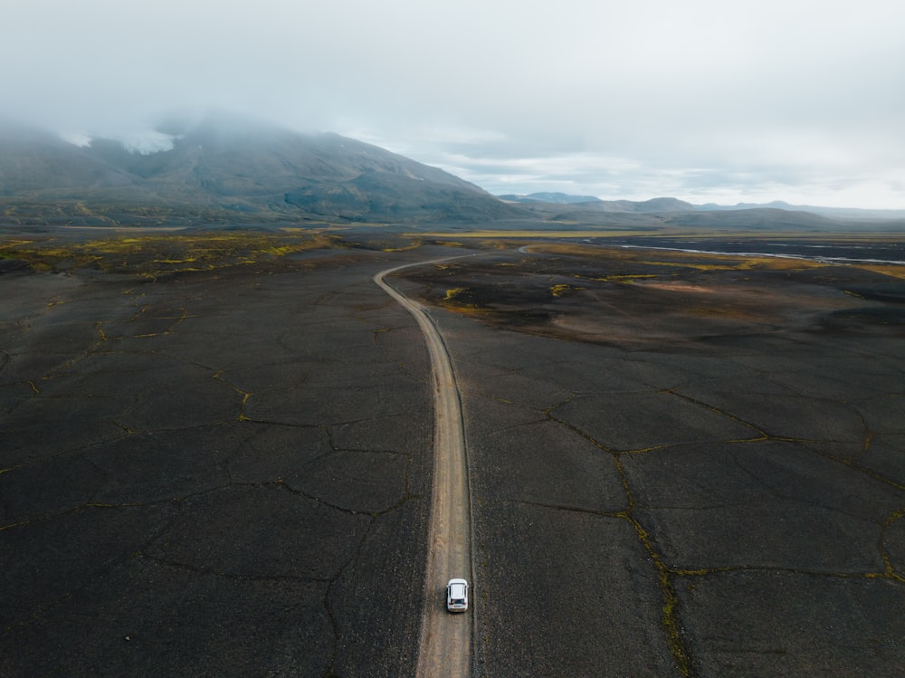 an aerial view of a car driving down a road