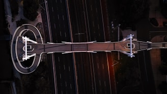 an aerial view of a road and a clock tower