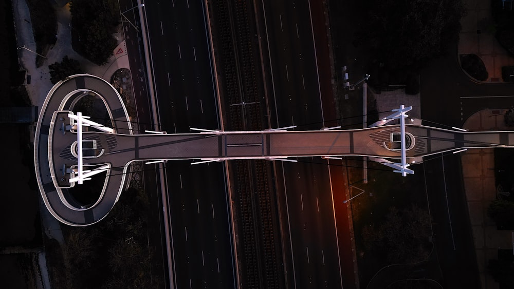 an aerial view of a road and a clock tower