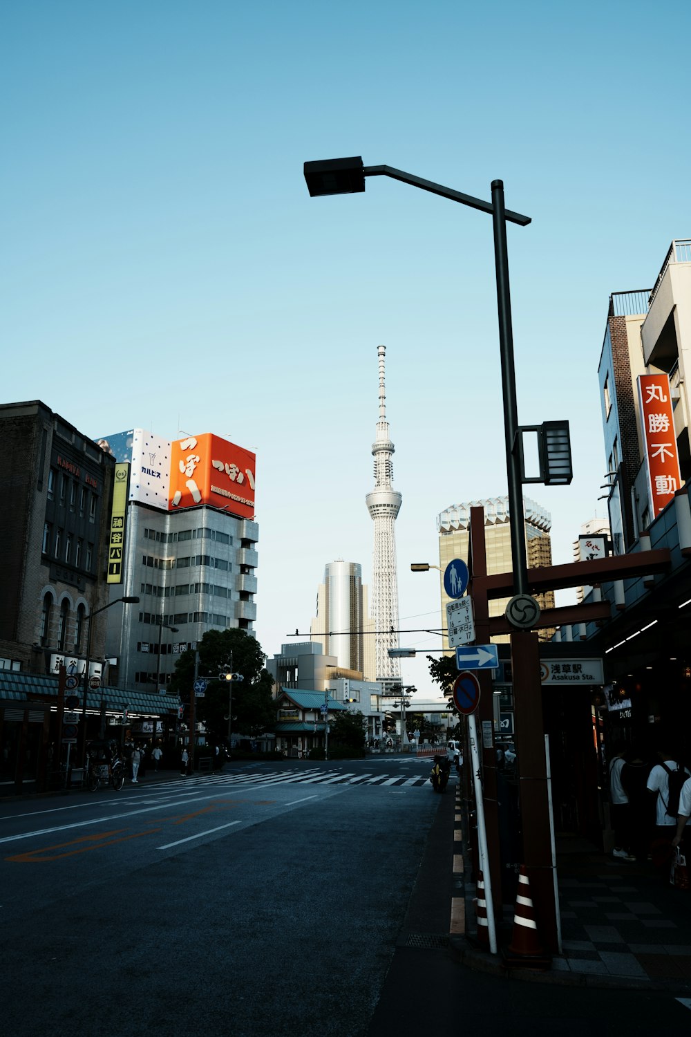 a city street with tall buildings in the background