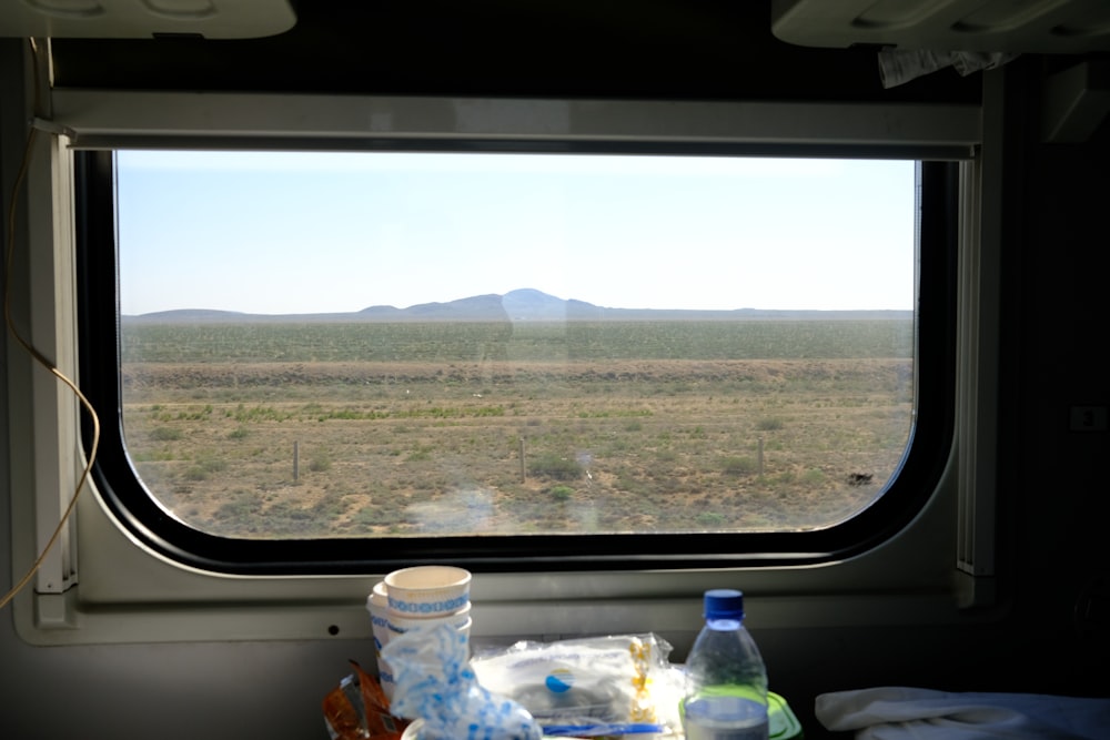 a view out a train window of a desert landscape