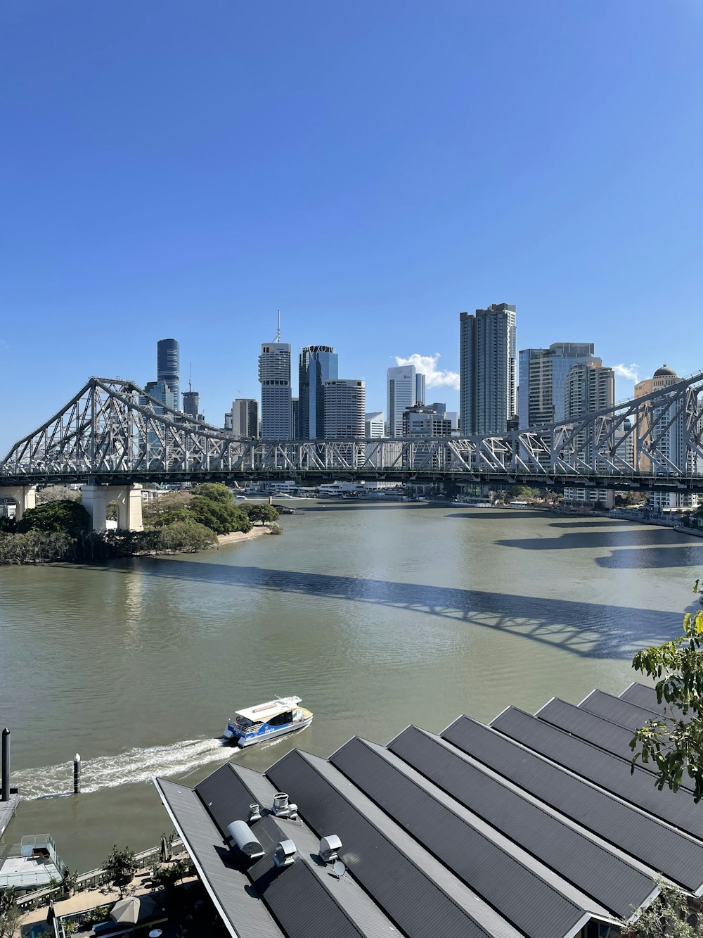 a boat traveling down a river next to a city