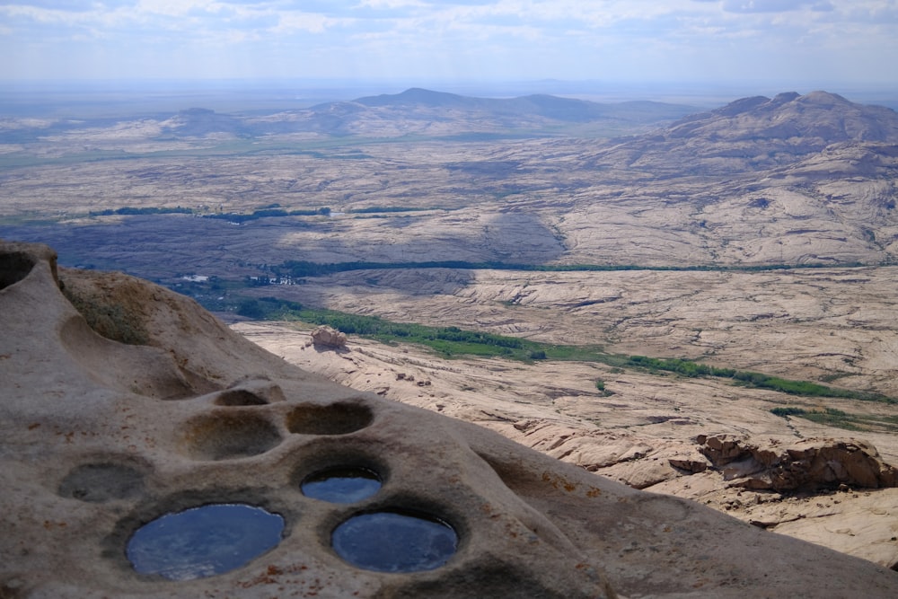 a rock formation with holes in the middle of it