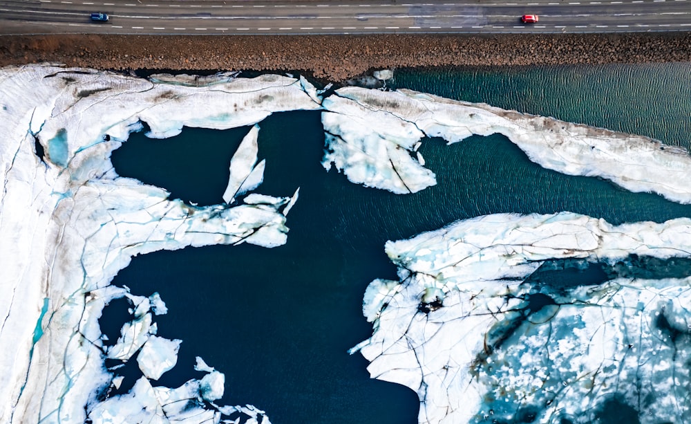 an aerial view of a car driving on an icy road