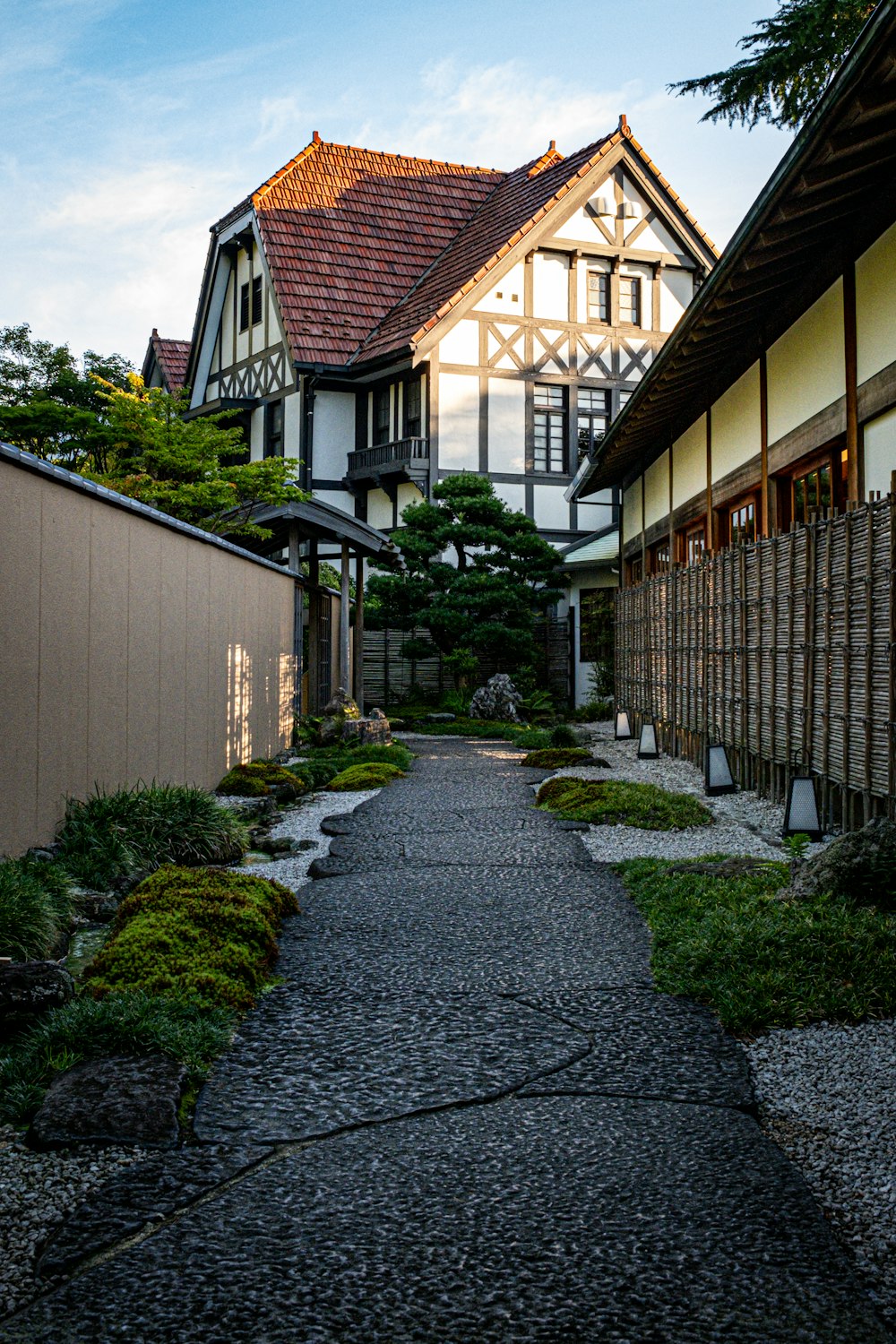 a walkway in front of a building with a clock on it