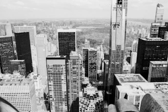 Black and white aerial drone shot over a cityscape.