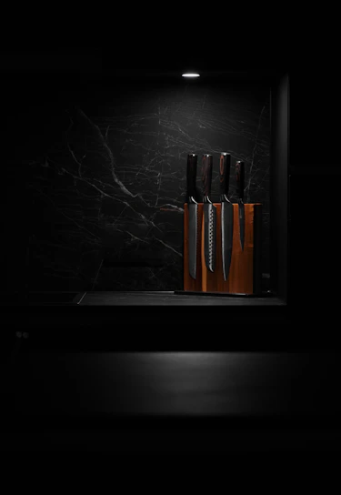 A bright, clear photo of a sleek kitchen knife set displayed on a white background.